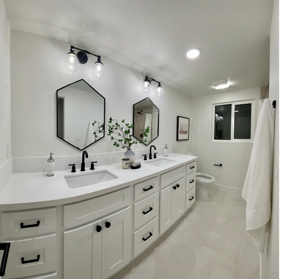 Sleek & Sophisticated: Double Vanity White Bathroom with Bold Black Hardware