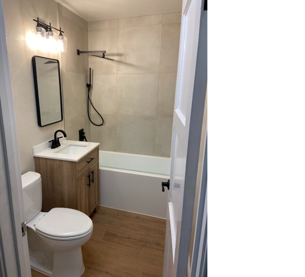 Modern Elegance: White Sink & Tub with Wood Cabinet and Black Accents