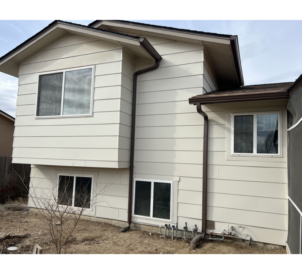 Soft & Stunning: Light Beige Exterior with White Windows and a Rich Brown Roof