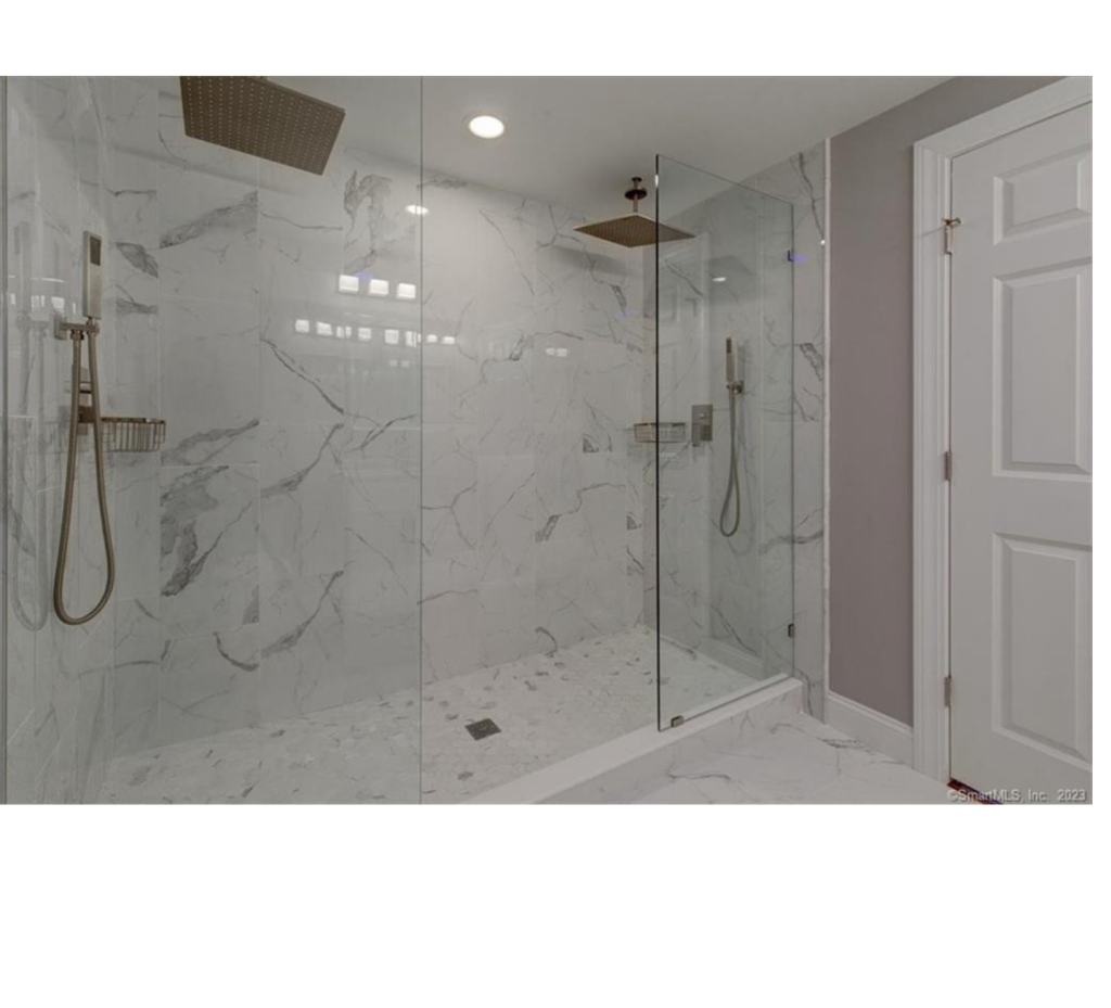 Double the Style: Luxe Bathroom Remodel with Twin Showers & Marble Walls
