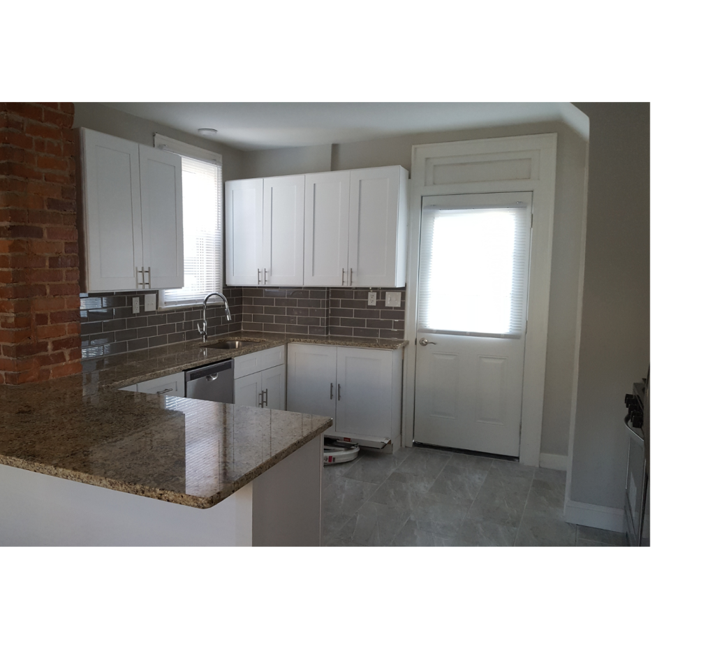 White Kitchen Design: Brick Post Accents & Brown Countertops for Warmth