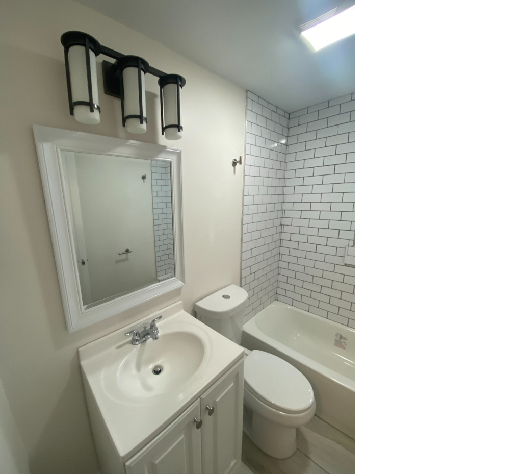 Timeless White Bathroom with Bold Black Lighting for a Sleek Contrast