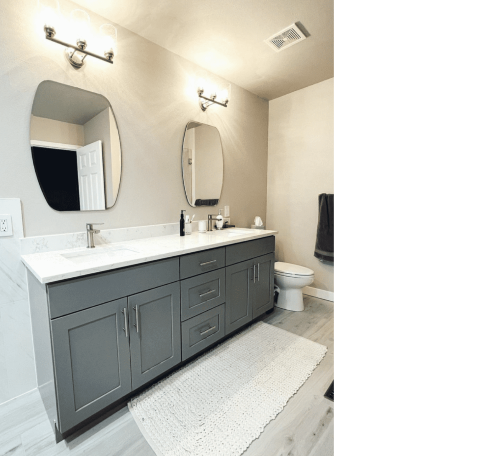 Dual Vanity Perfection: Gray Cabinets, Twin Mirrors & Light Wood Floors