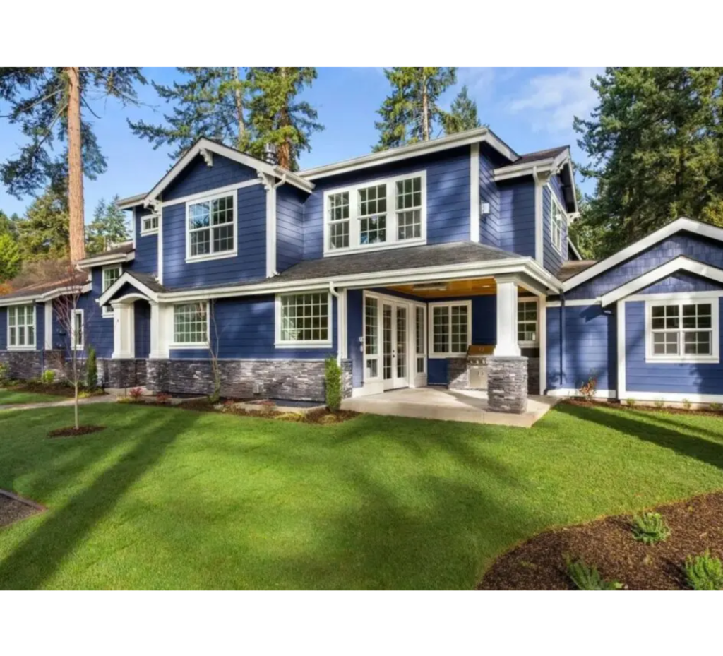 Classic Meets Contemporary: Blue Panels, Brick Charm & Crisp White Trim in a Picture-Perfect Landscape