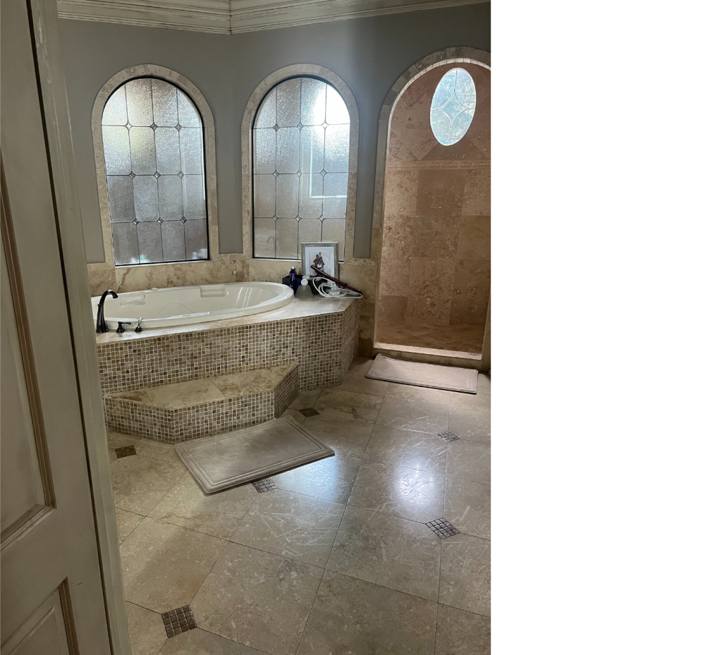 Earthy Elegance: Light Brown Batic Tiles, White Tub Accent & Arched Views