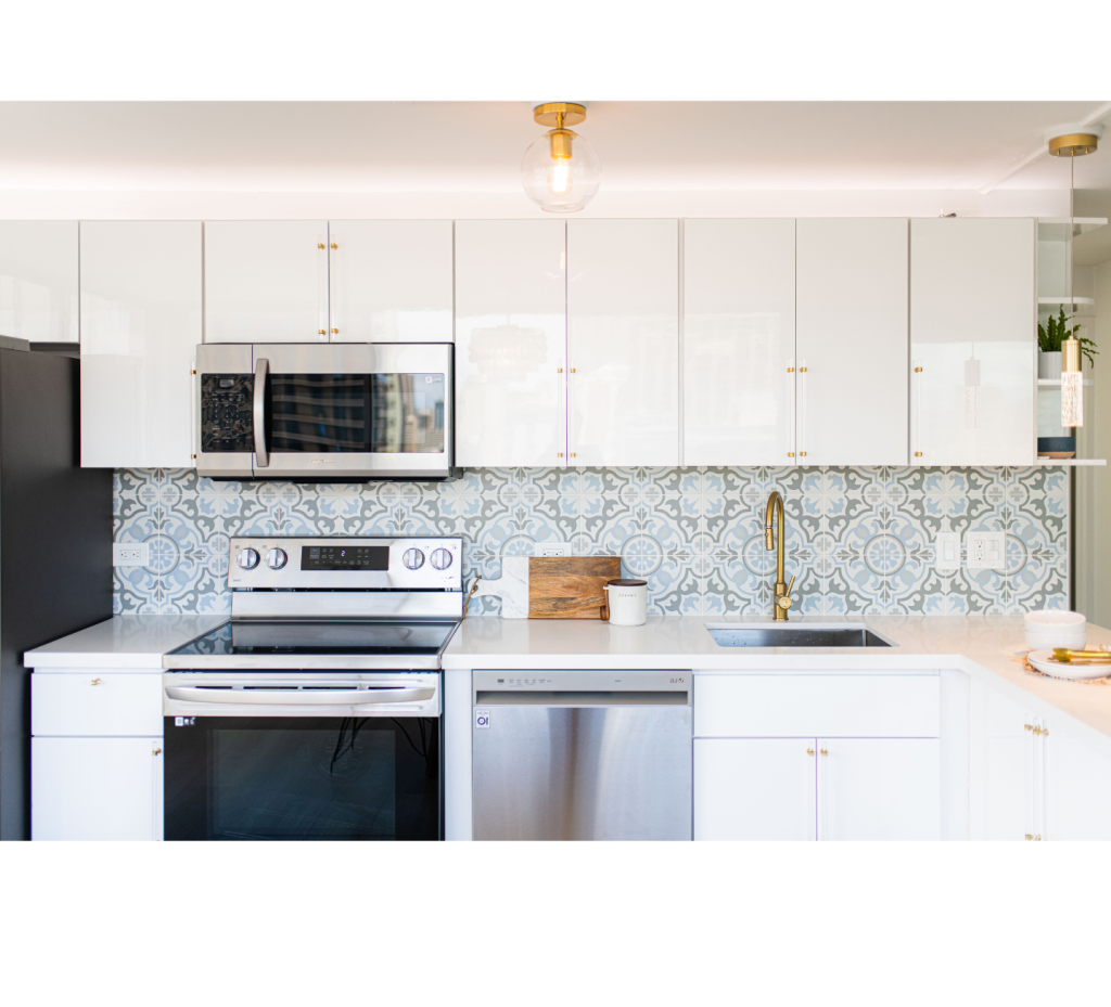 Chic & Sleek: White Cabinets, Gold Hardware, and Bold Black-Silver Appliances