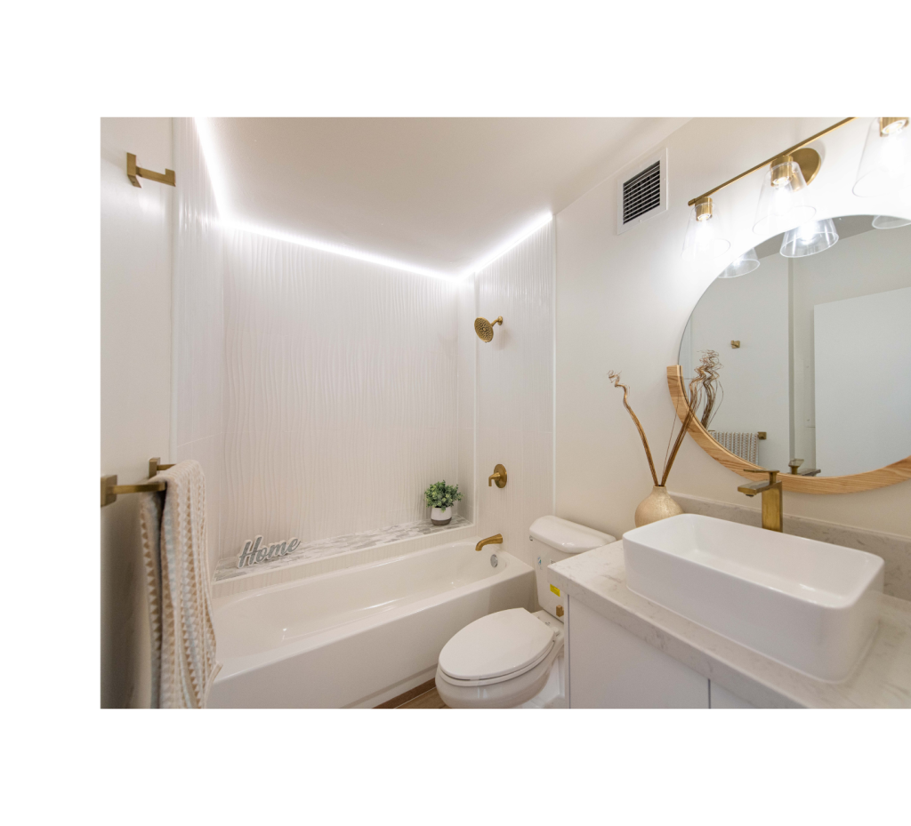 Elegant & Luxe: White Tub, Gold Shower Hardware & Wood Mirror for a Timeless Bathroom