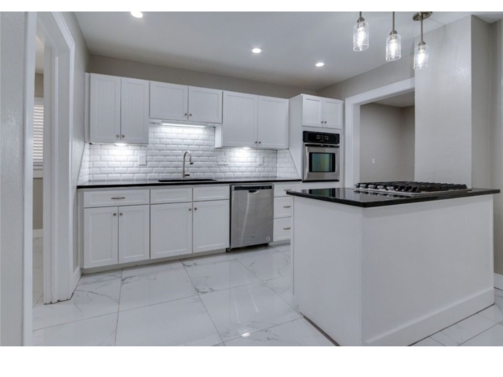 Crisp White Kitchen: Bold Black Countertops