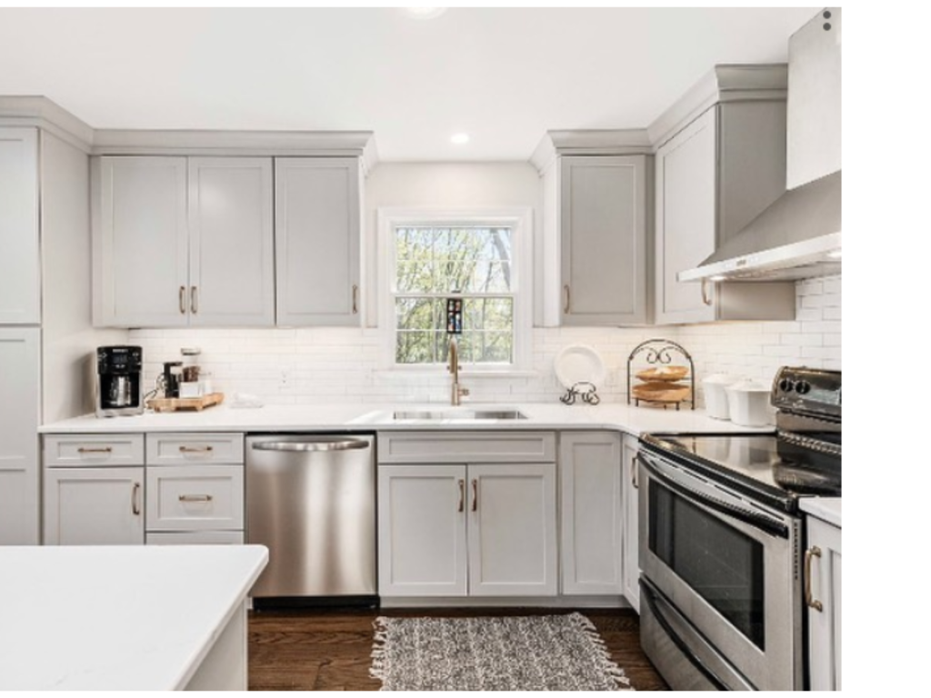 The view highlights the L-shaped layout and the peninsula or island with shiplap detailing.