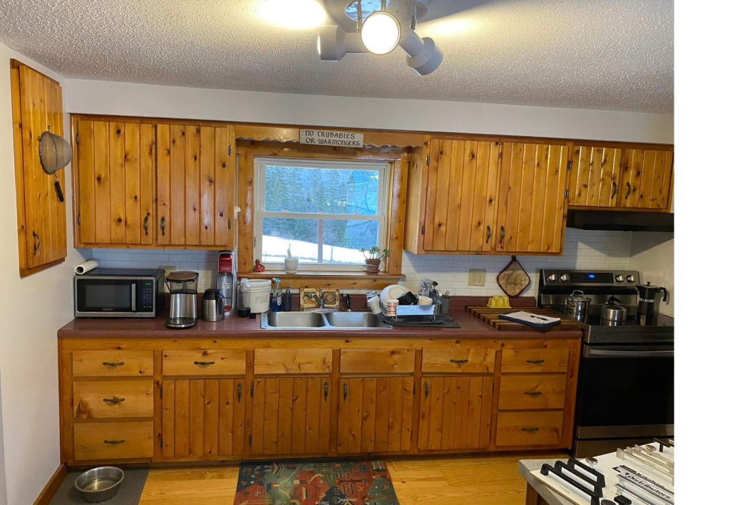 Cozy Rustic Charm: Knotty Pine Kitchen with Warm Wood Accents