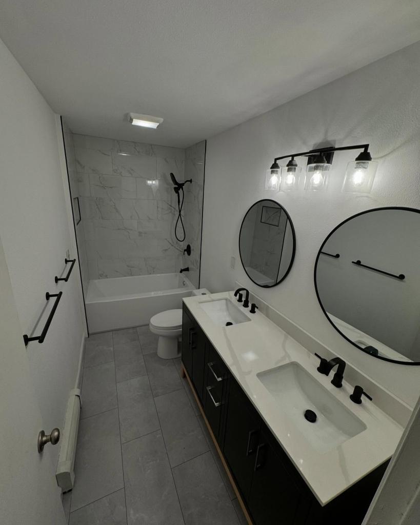 Sleek Simplicity: White Bathroom Remodel with Bold Black Accents
