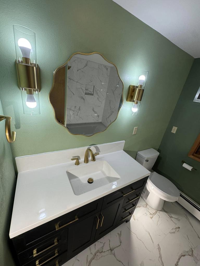Fresh Elegance: White Bathroom Remodel with Light Green Walls & Gold Hardware