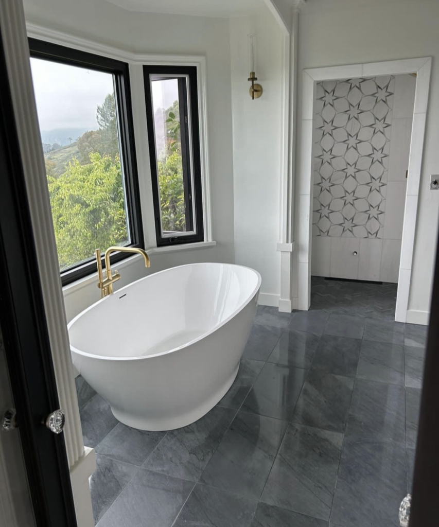 Luxe Fusion: White Tub, Gray Marble & Black Accents in a Stunning Bathroom Remodel