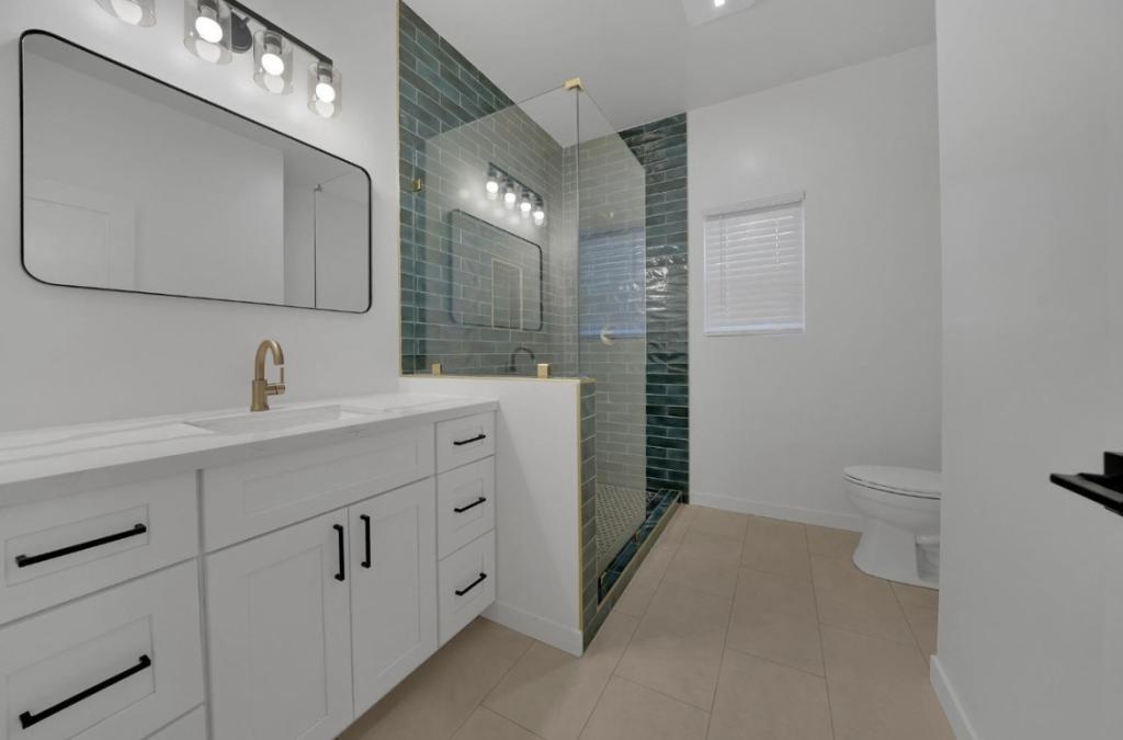 Fresh & Bold: White Bathroom Remodel with Emerald Tile and Striking Black Accents