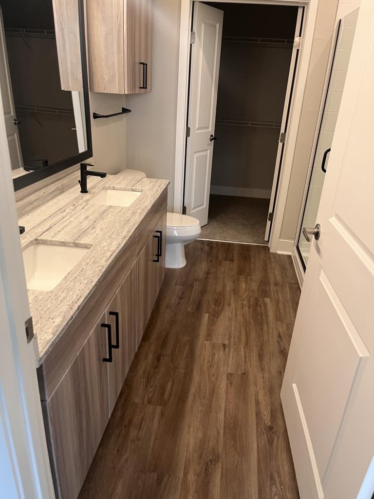 Modern Contrast: White Bathroom Remodel with Black Hardware & Wood Accents