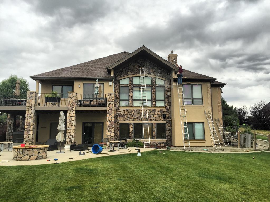 Natural Elegance: Light Beige Home with Stone Accents, Brown Windows & Roof
